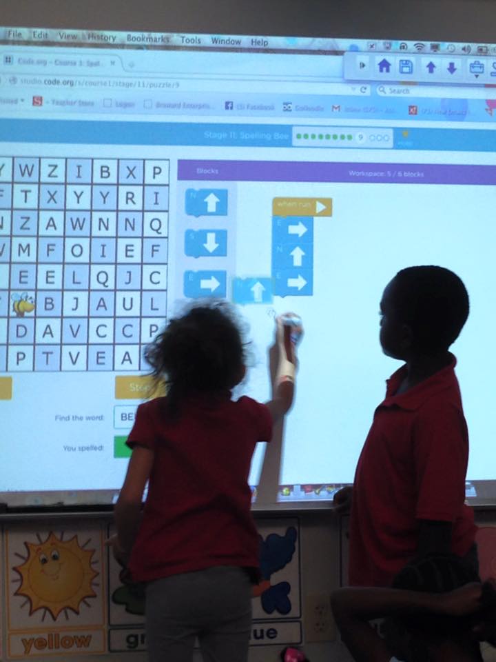 Students coding on the board